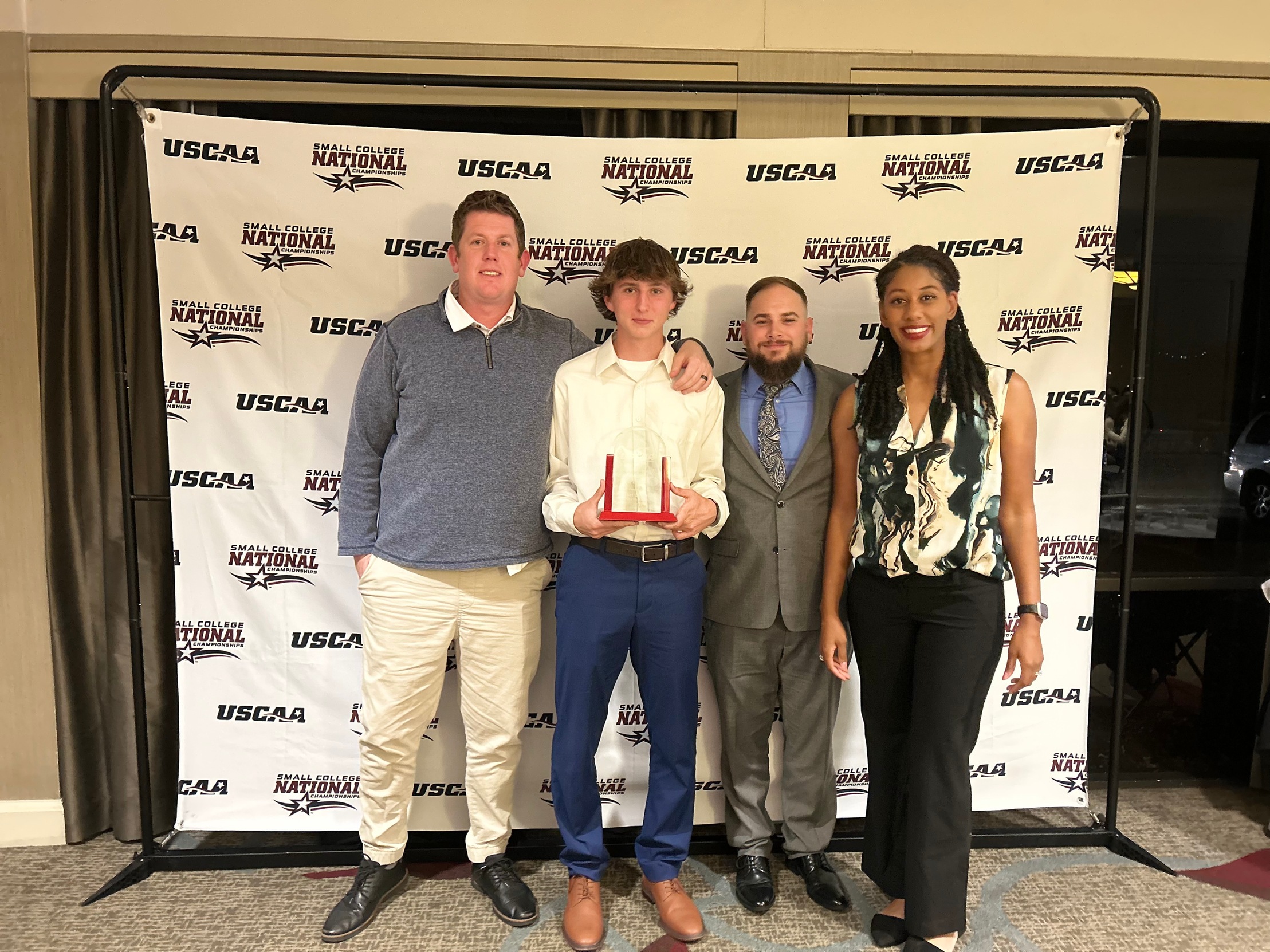 Left to Right: Coach Mark Duffield, Michael &quot;Mac&quot; Chaloupka, Steven Bressler (Assistant Athletic Director), and Dr. Renee Brown-Antonelli (Director of Athletics)
